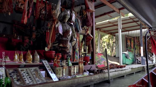 Boat trip across the asian floating market Damnoen Saduak in Ratchaburi, Thailand. Scenery float market, exchange of goods and local merchant people. Travel to Asia to discover new cultures.