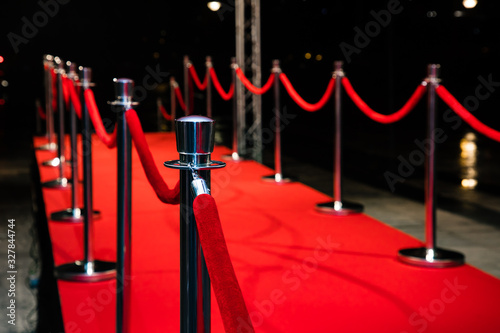 Red carpet with barriers and red ropes.