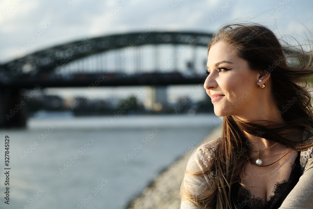 Fototapeta premium Beautiful stylish woman sitting on street stairs on summer day