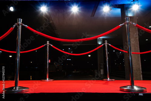 Red carpet with barriers and red ropes.