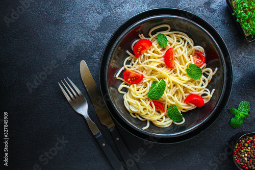 spaghetti pasta with tomatoes  Italian cuisine main dish  vegetarian menu concept background. top view. copy spaces