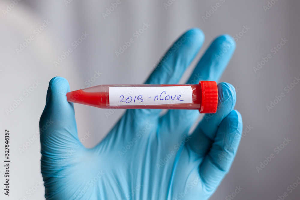Obraz premium test tube in hand, inscription virus, coronavirus study, virus research