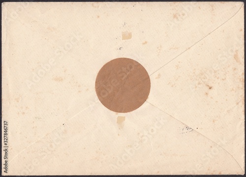 The reverse side of an old sealed mail envelope is gray-beige, with a vintage paper texture