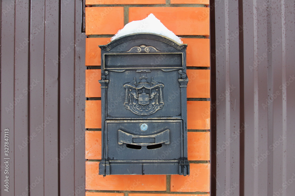 Vintage mailbox on red brick background