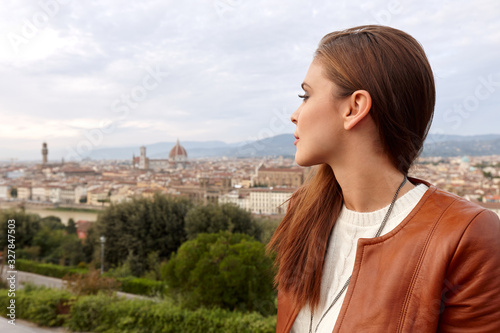 A young woman with a panorama of Florence behind her.