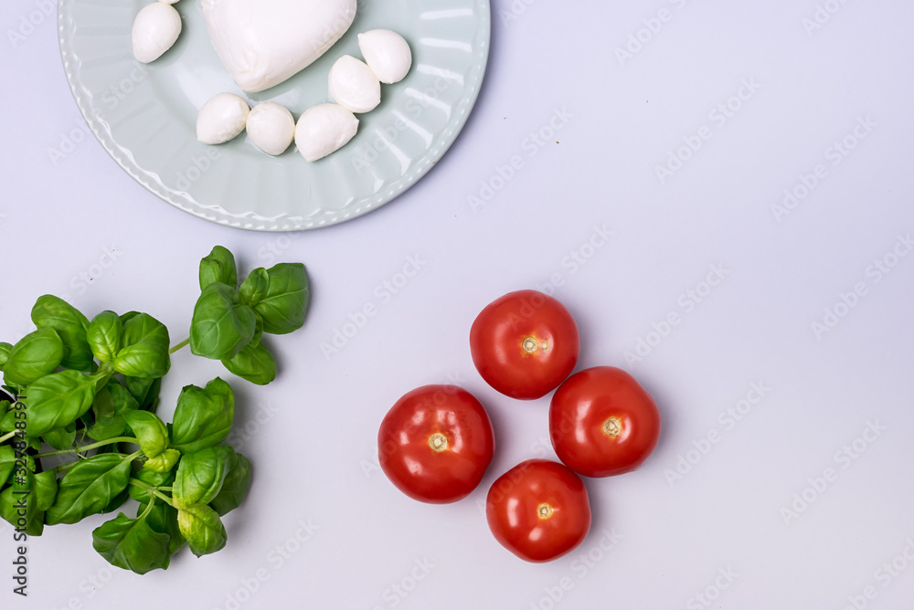 Potted Ripe Basil Plate of Mozarella Cheese Ripe Tomatoes on Blue Background Ingredient for Caprese Salad Italian Top View Flat Lay Potted Ripe Basil Plate of Mozarella Cheese Ripe Tomatoes on Blue Background Ingredient for Caprese Salad Italian Top View Flat Lay