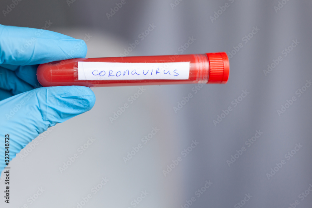 Obraz premium test tube in hand, inscription virus, coronavirus study, virus research