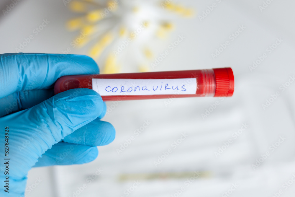 Obraz premium test tube in hand, inscription virus, coronavirus study, virus research