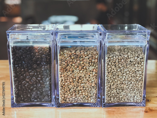 Coffee beans in three glass jars on the table