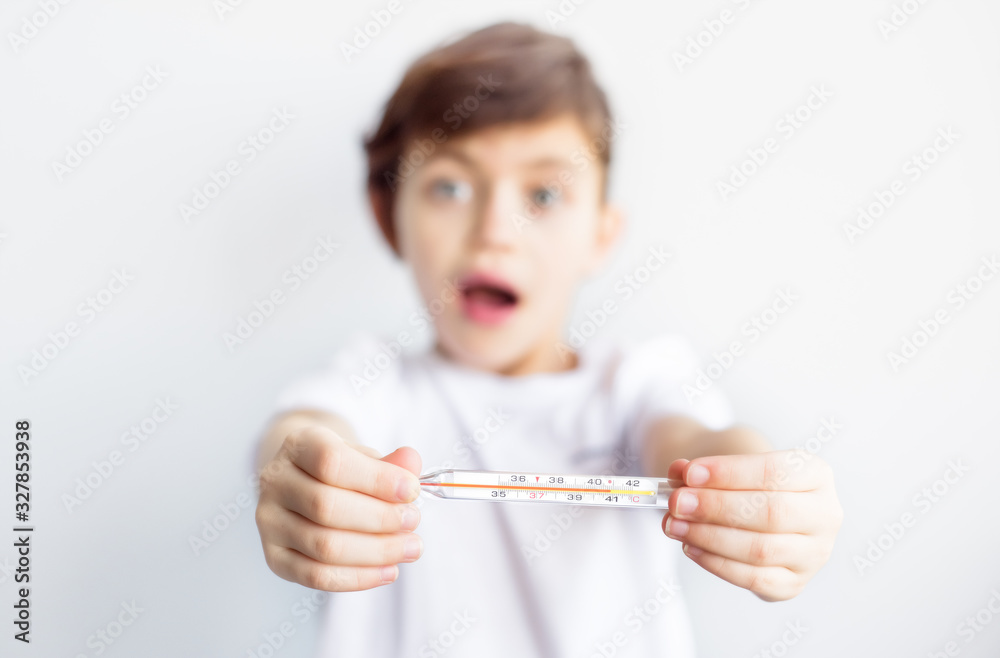 Portrait of scared frightened blurred faced child with thermometer in hands. Worldwide epidemic of coronavirus covid-2019. Health and medical care. Quarantine. Insurance Portrait of scared frightened blurred faced child with thermometer in hands. Worldwide epidemic of coronavirus covid-2019. Health and medical care. Quarantine. Insurance