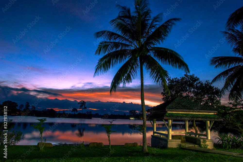 Wallpaper blurred nature of the twilight light in the evening by the large water basin surrounded by big trees, the integrity of the forest Wallpaper blurred nature of the twilight light in the evening by the large water basin surrounded by big trees, the integrity of the forest