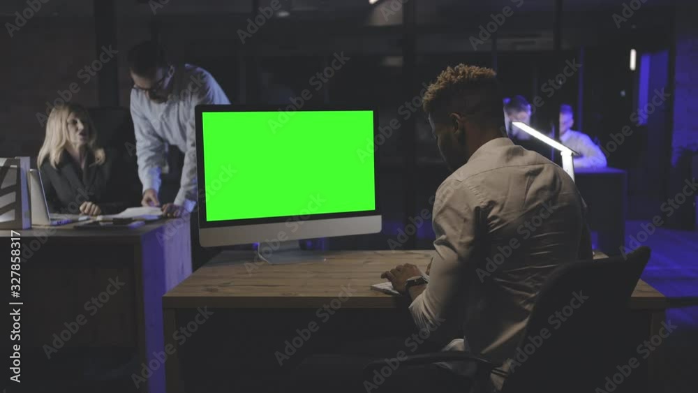 Young man working at computer late at night Young man working at computer late at night