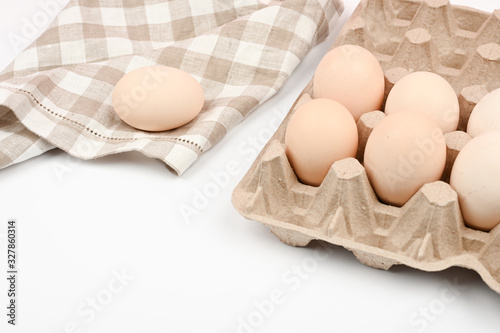 A tray with eggs on a white table. eco tray with eggs on a white background, the trend of minimalism, top view. Egg tray photo