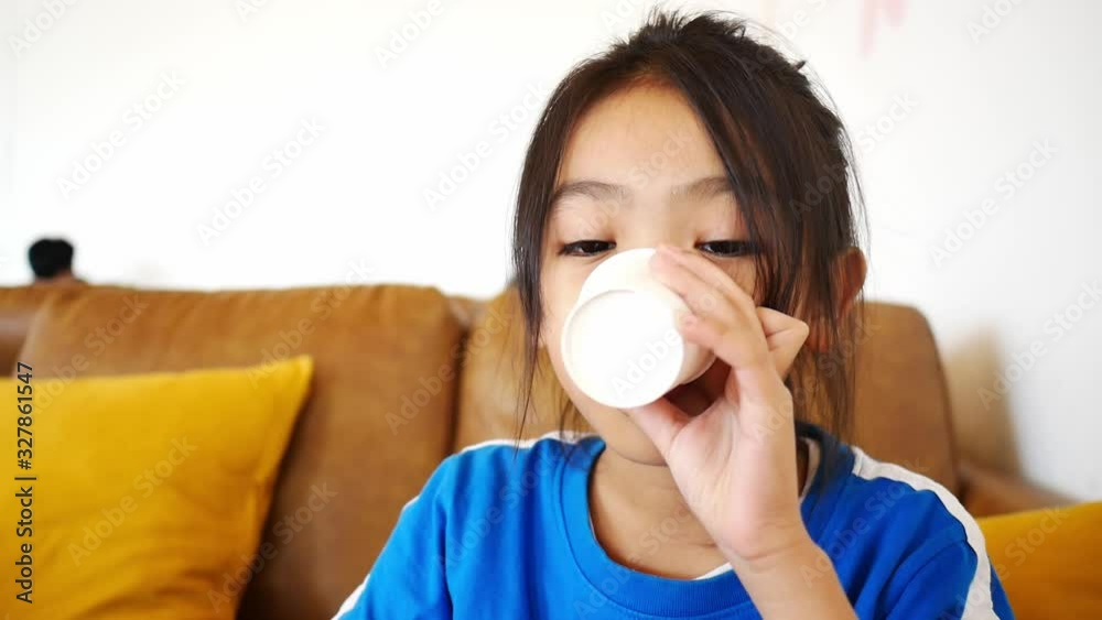 Portrait of Asian children when drinking water from a paper cup Portrait of Asian children when drinking water from a paper cup