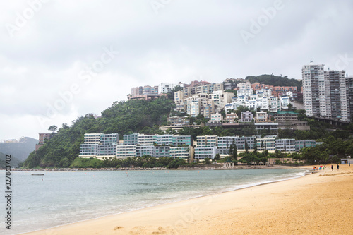 resedential building surrounding with green mountain and sand beach photo