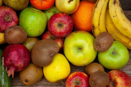 Fruit basket on a wooden kitchen table. Assorted fruits  set. Different multi-colored fruits. Vitamin nutrition.