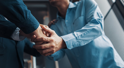 Business shaking hands, finishing up meeting. Successful businessmen handshaking after good deal.