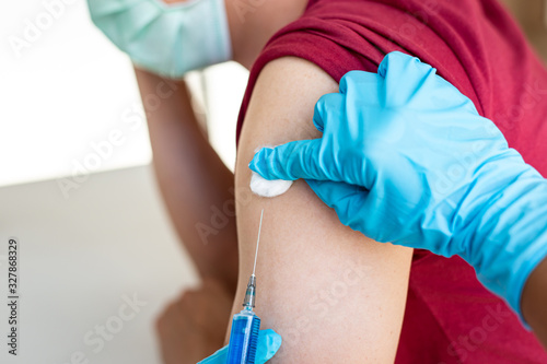 Doctors are vaccinating a new strain of flu patients to prevent the spread of the disease and the epidemic in all ages  Vaccination against communicable diseases concept