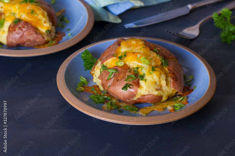 Twice Baked Potatoes with Bacon, Cheese and Scallion. Potato in jacket. Horizontal image Twice Baked Potatoes with Bacon, Cheese and Scallion. Potato in jacket. Horizontal image