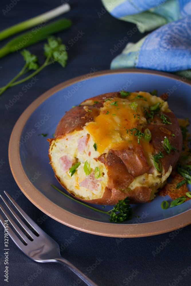 Twice Baked Potatoes with Bacon, Cheese and Scallion. Potato in jacket. Vertical image Twice Baked Potatoes with Bacon, Cheese and Scallion. Potato in jacket. Vertical image