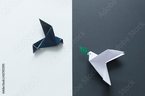 White and black paper doves, peace and war concept. 