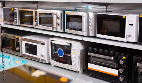 Fototapeta Naklejka Na Ścianę i Meble -  Image of assortment of a kitchen microwave at household  appliances store