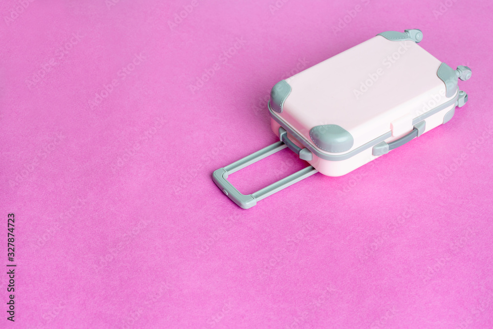 Pink suitcase on a pink background. Minimalism. Pink suitcase on a pink background. Minimalism.