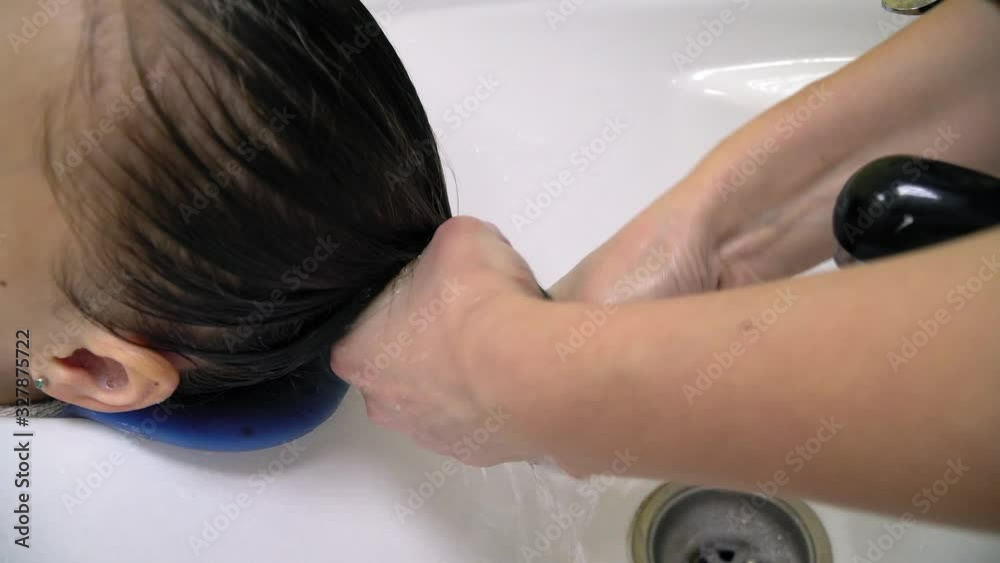 Professional hairdresser doing evening hairstyle for girl. 4K Professional hairdresser doing evening hairstyle for girl. 4K