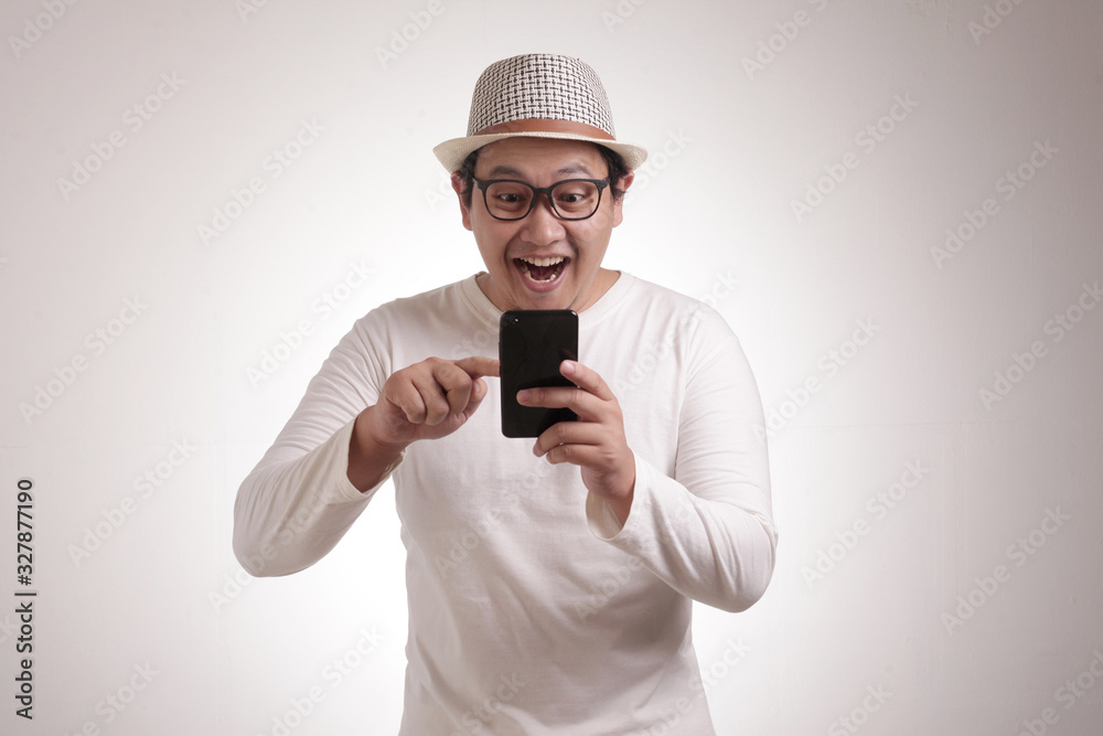 Young Man Texting Reading Chatting on His Phone, Smiling Happy Young Man Texting Reading Chatting on His Phone, Smiling Happy
