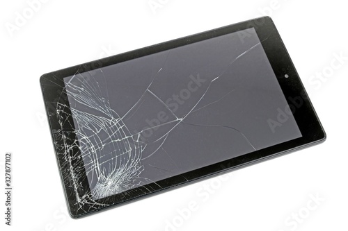 A computer tablet with a smashed display screen on a white background