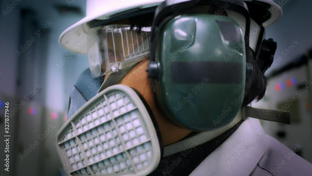 A worker wearing a Multi-purpose respirator half mask for protection gas and dust. Industrial and safety concept A worker wearing a Multi-purpose respirator half mask for protection gas and dust. Industrial and safety concept