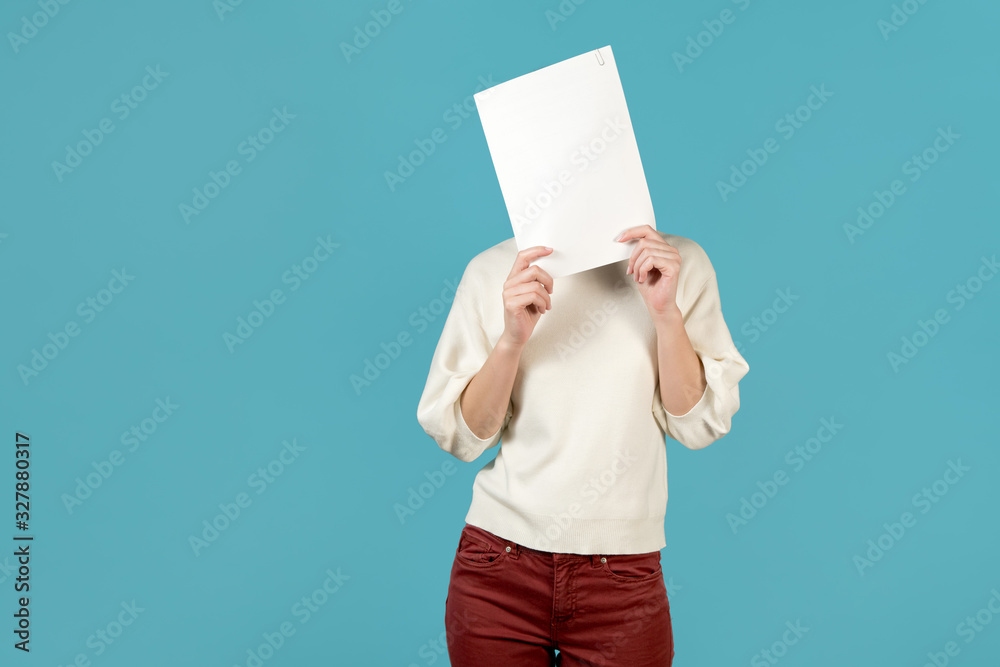 girl covers her face with a stack of papers girl covers her face with a stack of papers