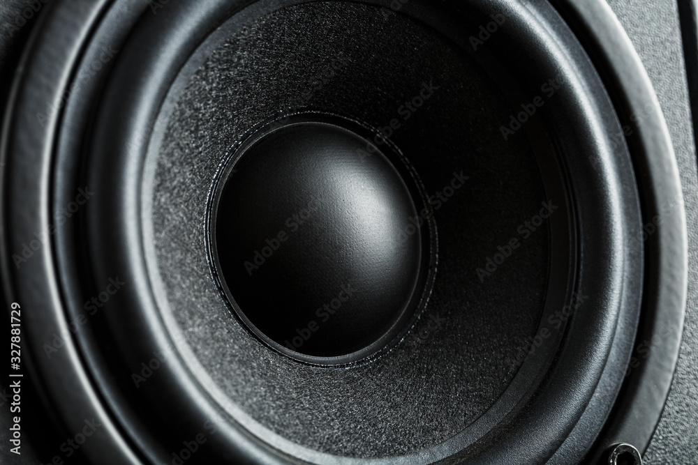 Multimedia speaker system speaker close-up on a black background. Multimedia speaker system speaker close-up on a black background.