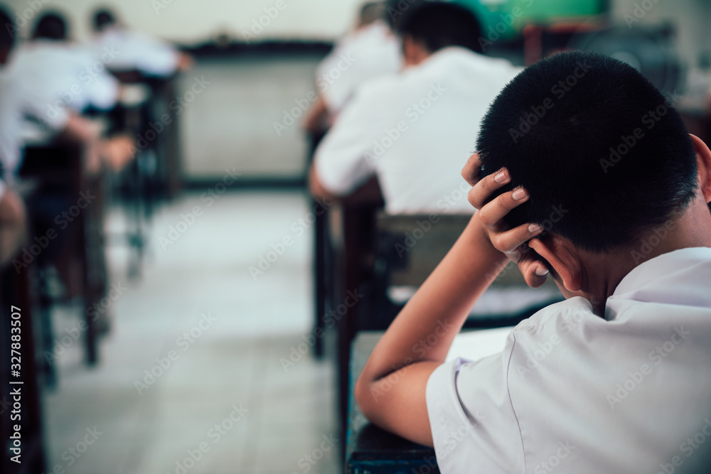 Students doing exam answer sheets exercises in classroom of school with stress. Students doing exam answer sheets exercises in classroom of school with stress.