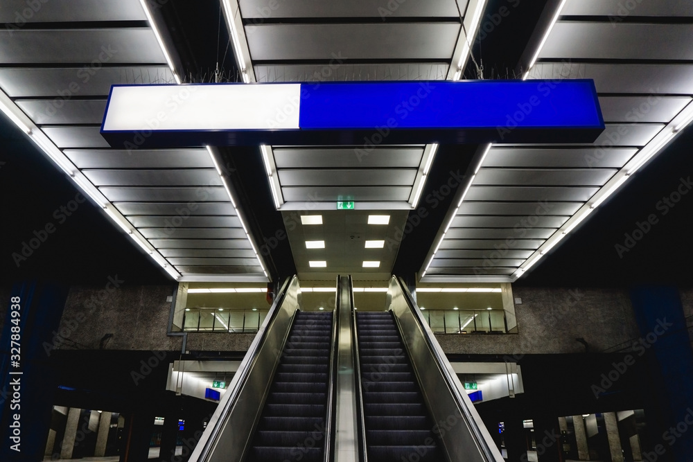 Naklejka premium Underground subway architecture. Train station platform. Grunge urban background. Moving staircase escalator.