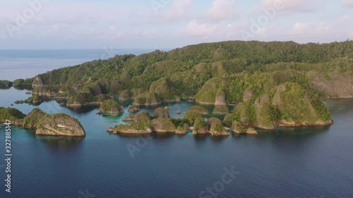 An aerial view shows rugged limestone islands rising from the seascape near Penemu, Raja Ampat, Indonesia. This area is well known by divers and snorkelers for its amazing marine biodiversity. photo