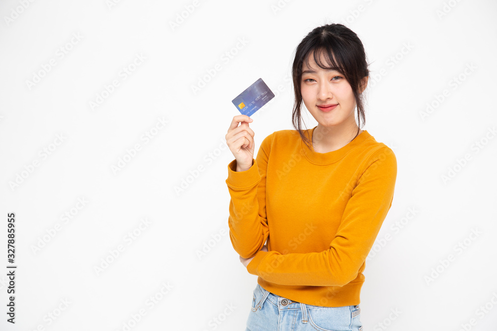 Happy Asian woman holding credit card or cash advances, Pay instead of money and specially curated benefits for lady card concept Happy Asian woman holding credit card or cash advances, Pay instead of money and specially curated benefits for lady card concept
