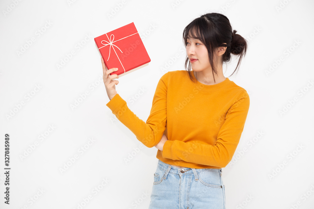 Happy beautiful asian woman smile with red gift box isolated on white background. Teenage girls in love, Receiving gifts from lovers. New Year, Christmas and Valentines Day concept Happy beautiful asian woman smile with red gift box isolated on white background. Teenage girls in love, Receiving gifts from lovers. New Year, Christmas and Valentines Day concept