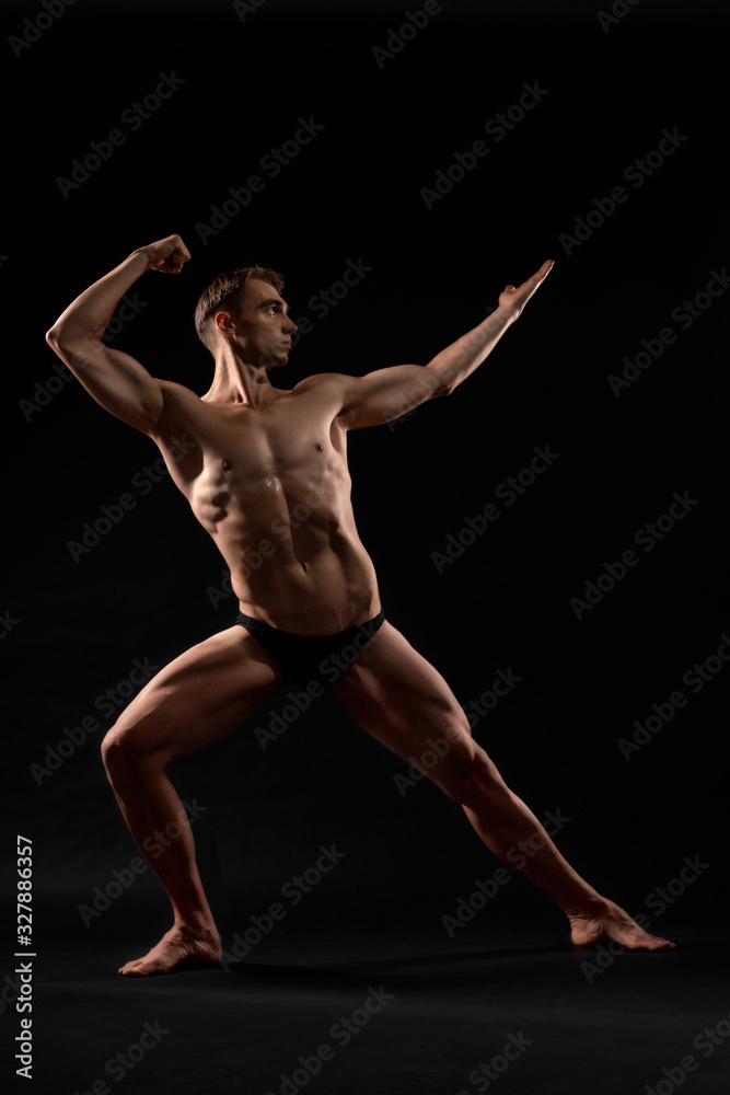 Male bodybuilder demonstrating contest pose. Male bodybuilder demonstrating contest pose.