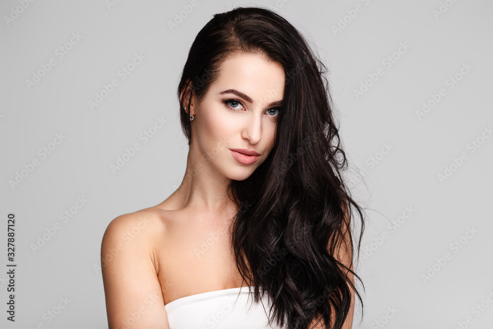 portrait of a young lady with beautiful brunette hair on grey portrait of a young lady with beautiful brunette hair on grey