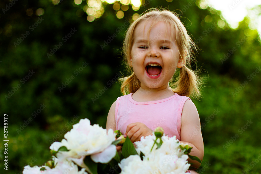 Happy little girl with flowers in the garden Happy little girl with flowers in the garden
