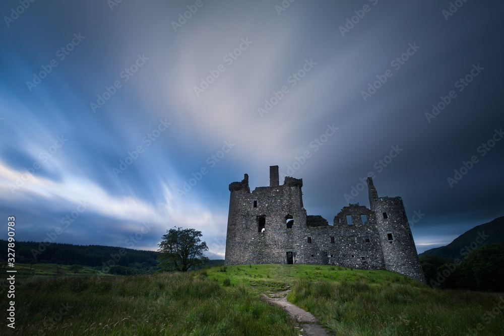 Kilchurn Castle in the Scottish Highlands landscape after rain with clouds