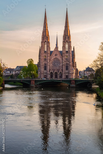 View of St. Paul's church and Auvergne bridge from Royal bridge. Ill river. Early spring. Beautiful reflection. Strasbourg, Alsace, France