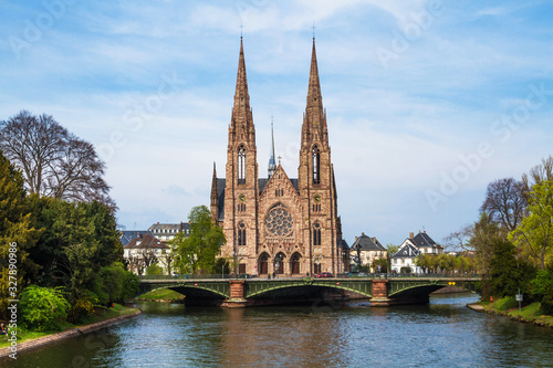 View of St. Paul's church and Auvergne bridge from Royal bridge. Ill river. Early spring. Strasbourg, Alsace, France