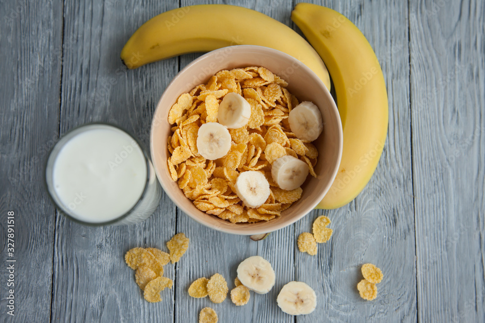 Healthy breakfast with glass of milk, bananas and corn flakes Healthy breakfast with glass of milk, bananas and corn flakes