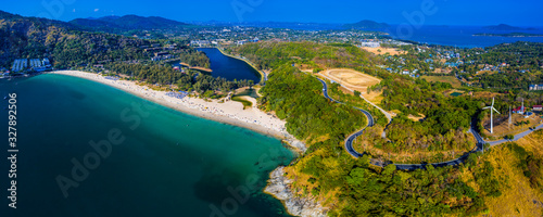 Aerial panorama of the island of Phuket during sunny day. Area of the Nai Harn beach and wind generator. Thailand