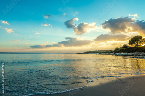 Fertilia shore under a clear sky at sunset