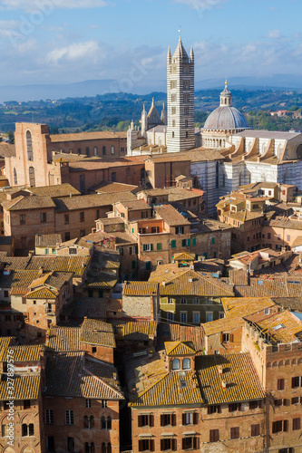 Scenery of Siena, a beautiful medieval town in Tuscany, with panoramic view of the Dome and Bell Tower of Siena Cathedral (Duomo di Siena), landmark Mangia Tower, Italy