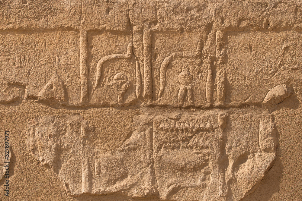 Karnak Temple, complex of Amun-Re. Embossed hieroglyphics on walls. Luxor Governorate, Egypt.