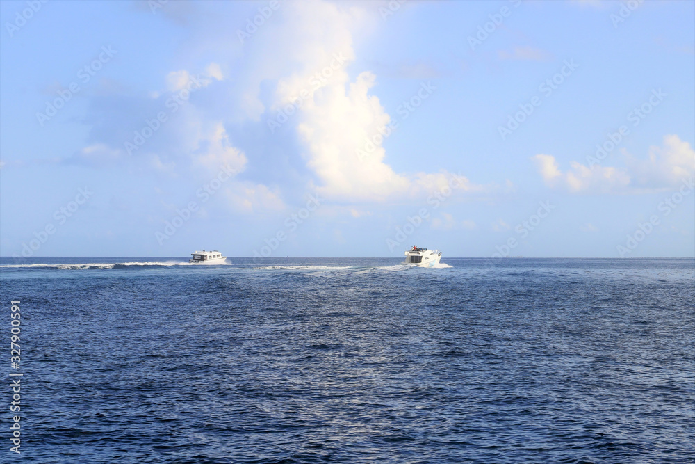  Small motorboats sail the blue sea of ​​the Maldives